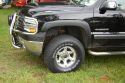 Here are some pics of the newest upgrade I've made to the truck, just in time to put it into storage while I run off to Guam, it seems.  Taller, wider tires and new rims.  I also lifted the front an additional 1.5-2" for tire clearance.